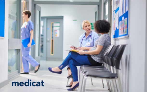 Medical clinic hallway with three people