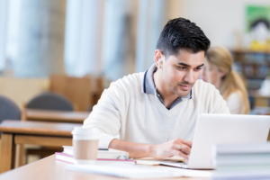 Student on laptop searching for accessibility services